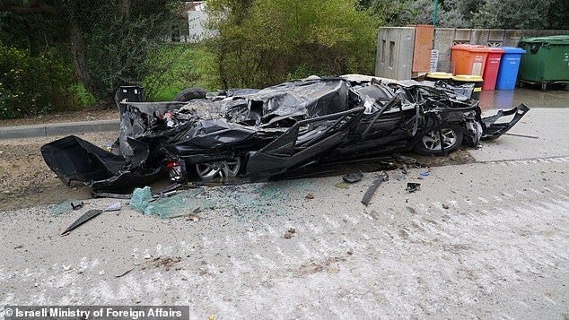 Cars were left flattened in the middle of the road in Be'eri, which sits just a few miles from the border with Gaza