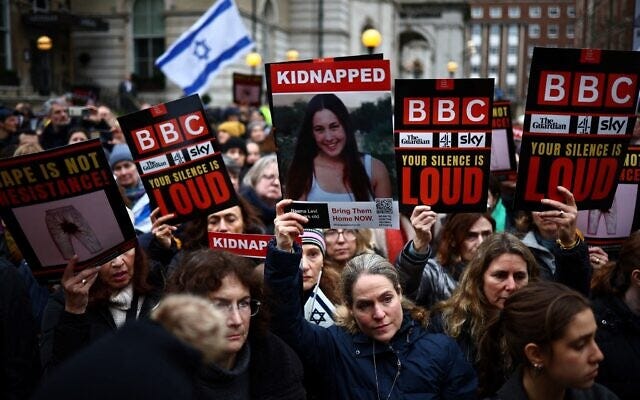 Protesters hold placards and wave Israeli flags as they take part in a "Rape is NOT resistance" demonstration outside the BBC headquarters, in London, on February 4, 2024 to bring attention to the plight of kidnapped Israeli women in Gaza. (HENRY NICHOLLS / AFP)