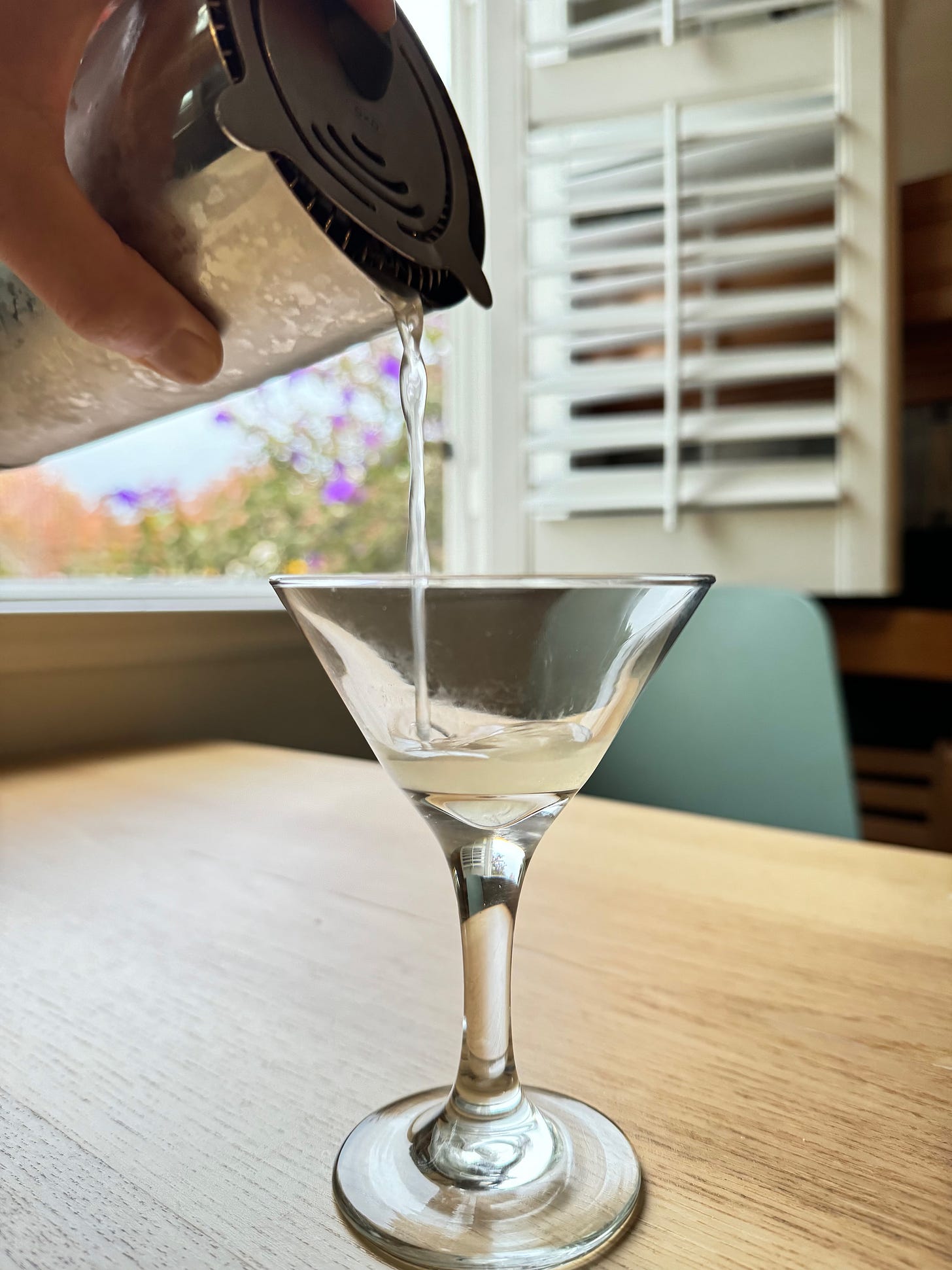 Pouring a cocktail into a glass