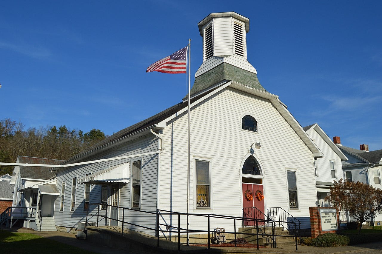 Church with U.S. flag flying in front of it.