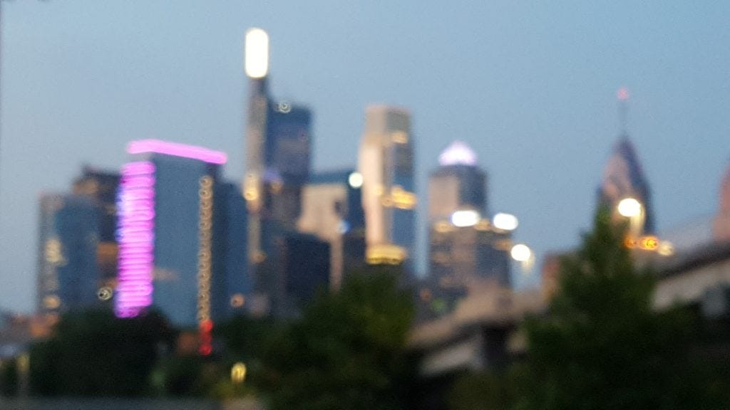 A blurry zoom in on the Philadelphia skyline at dusk. 