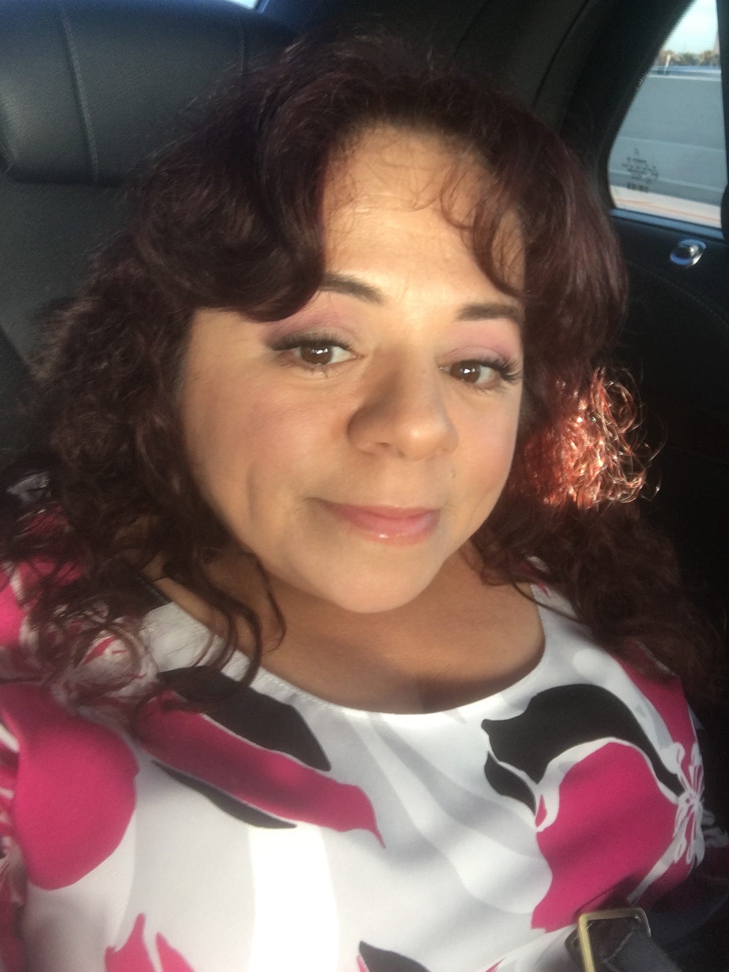 Nathasha Alvarez, founder of audacitymagazine.com takes a selfie in a town car.