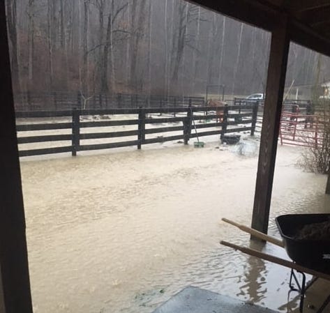 A barn and surrounding pasture is completely flooded