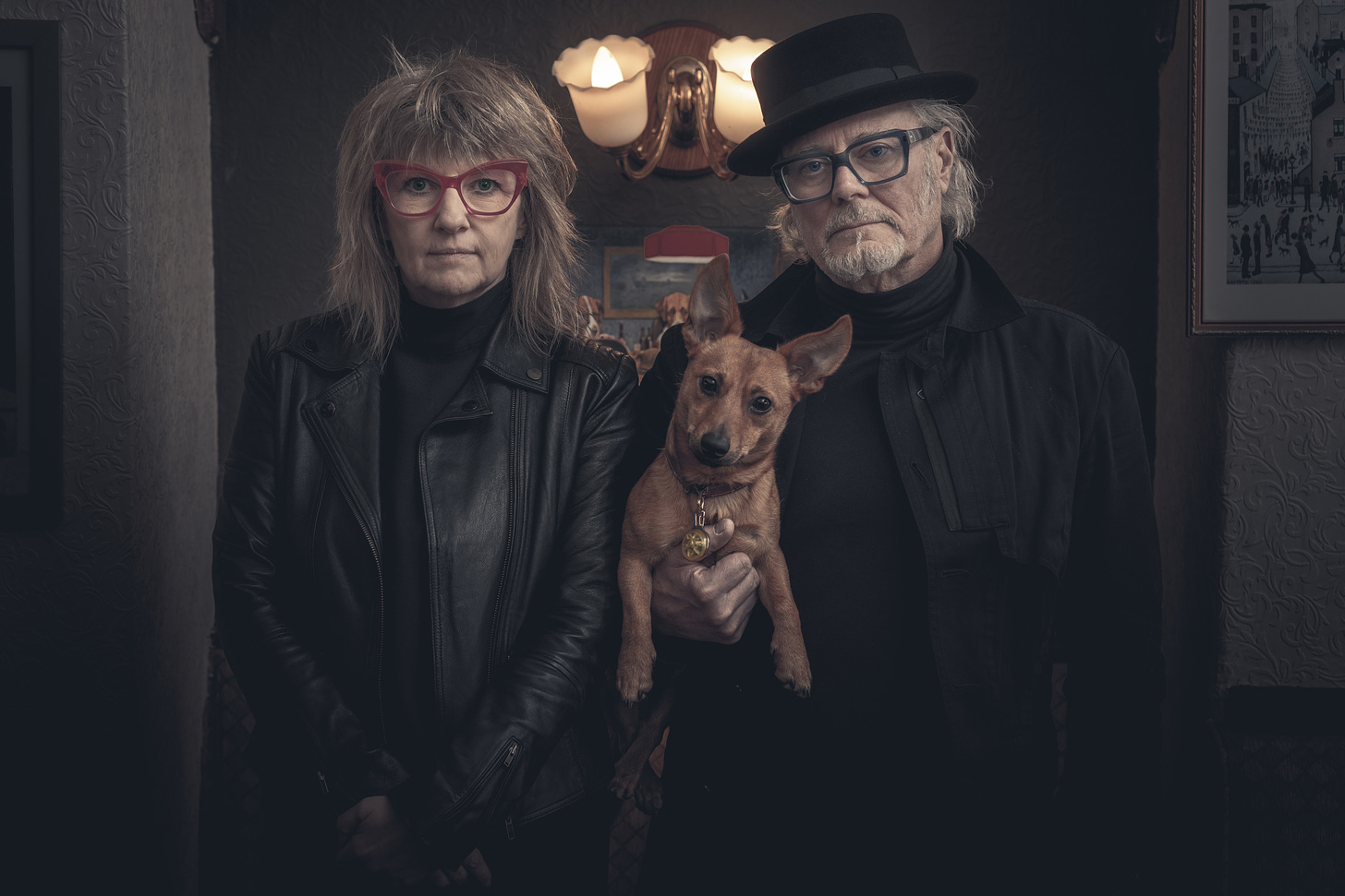 Suzy Starlite and Simon Campbell pictured with a random dog against a old school English pub background