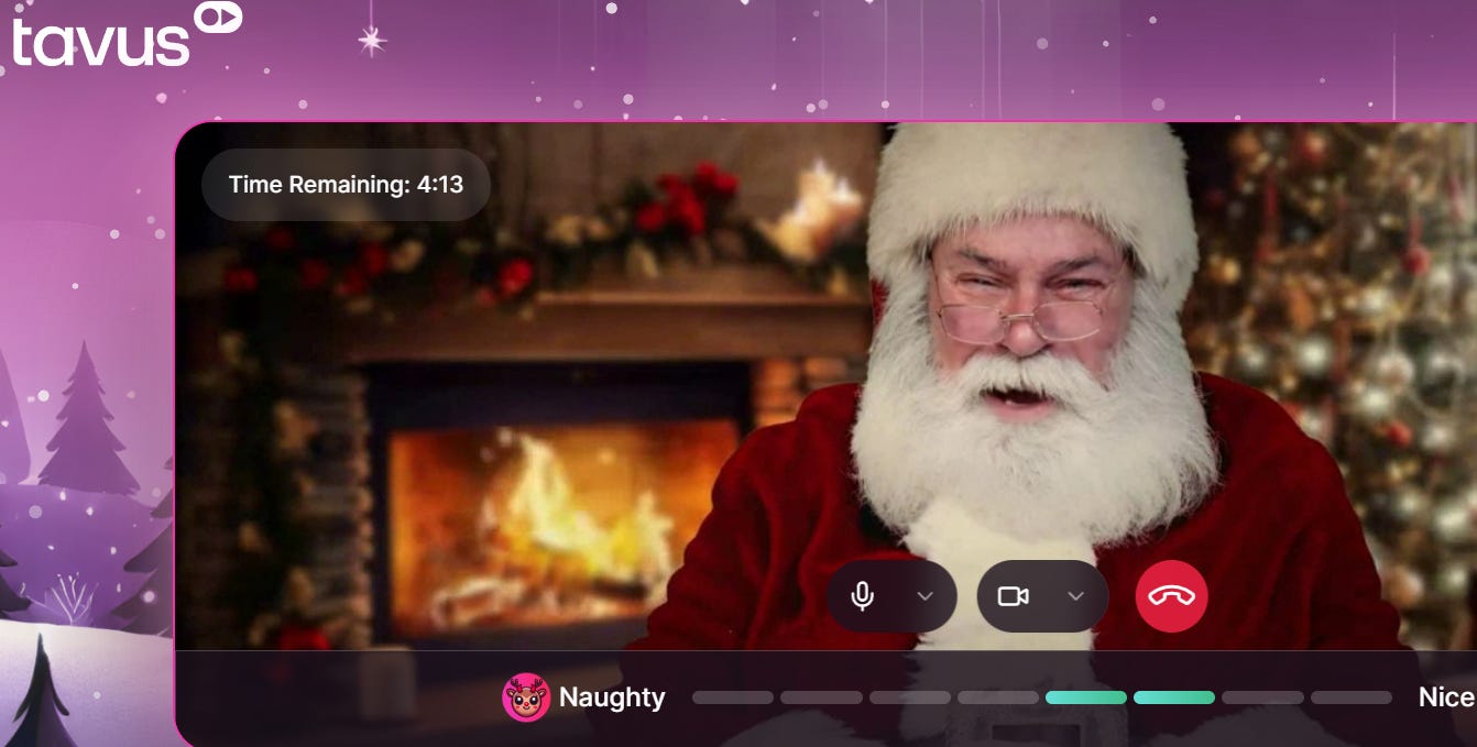 Video call with Father Christmas.  He is sat next to a roaring fire with decorations around in red and green.  The christmas tree has silver baubles hanging from it.  