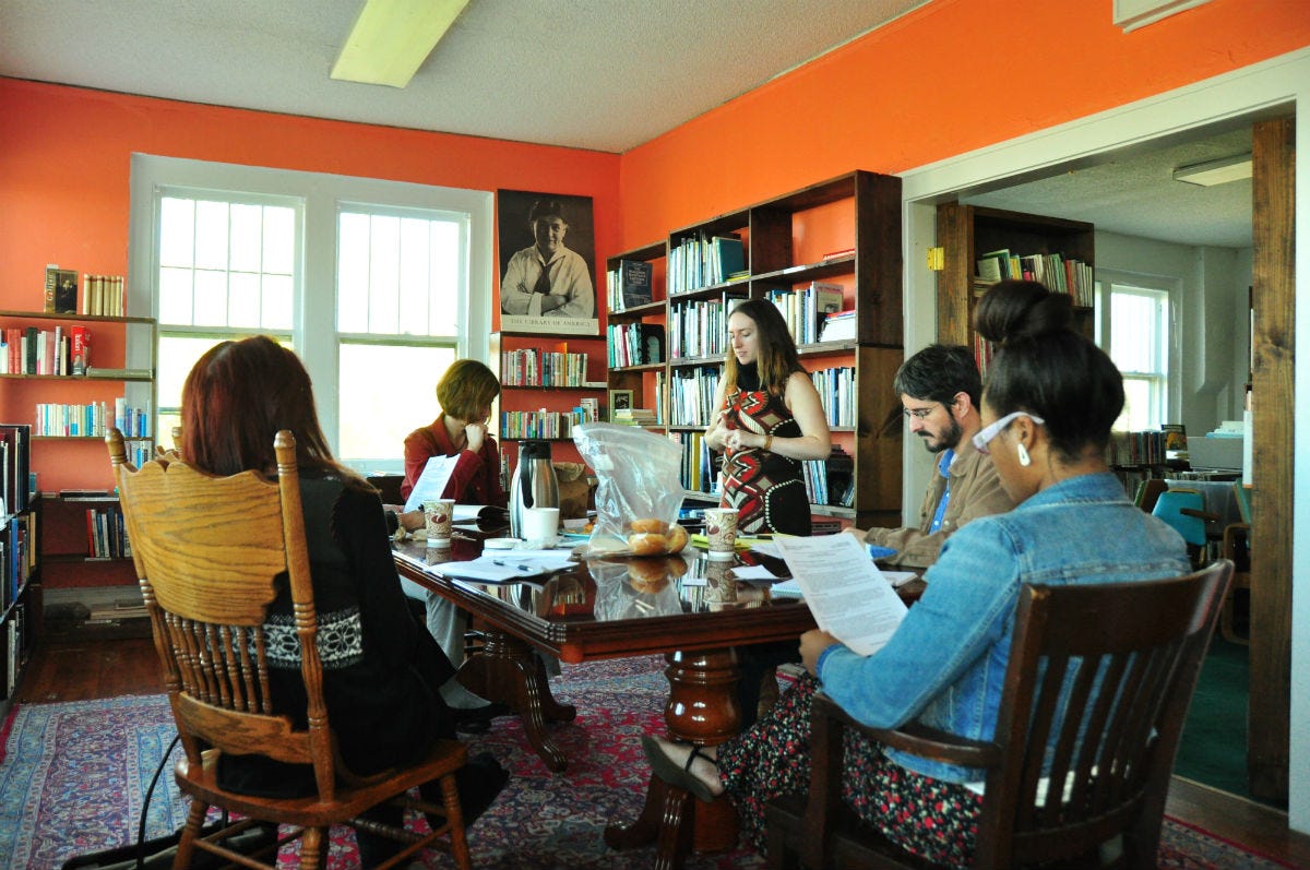 people sitting around a table at a book store