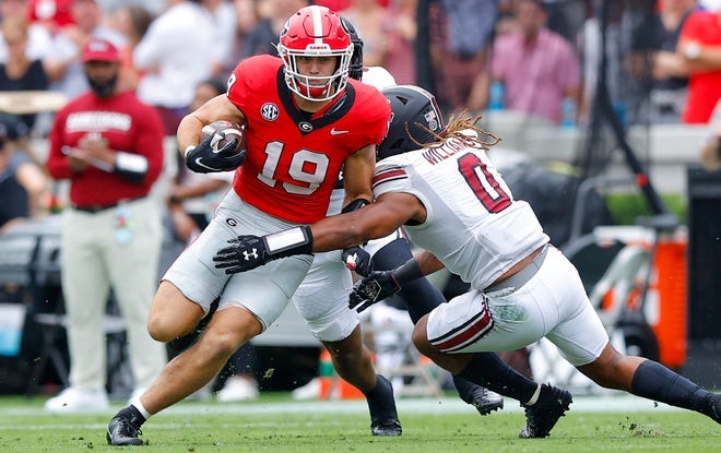 Georgia tight end Brock Bowers is tackled by South Carolina's Debo Williams during the first half at Sanford Stadium.