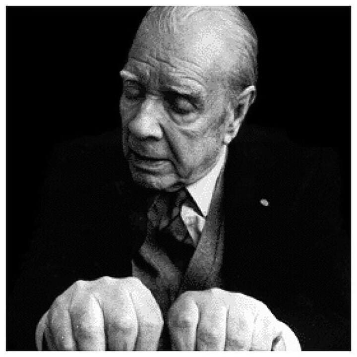 Black and white photo of Jorge Luis Borges. He is an old, white man with thin. white hair. He wears a suit and tie and has his eyes closed, hands curled up and seen in the foreground