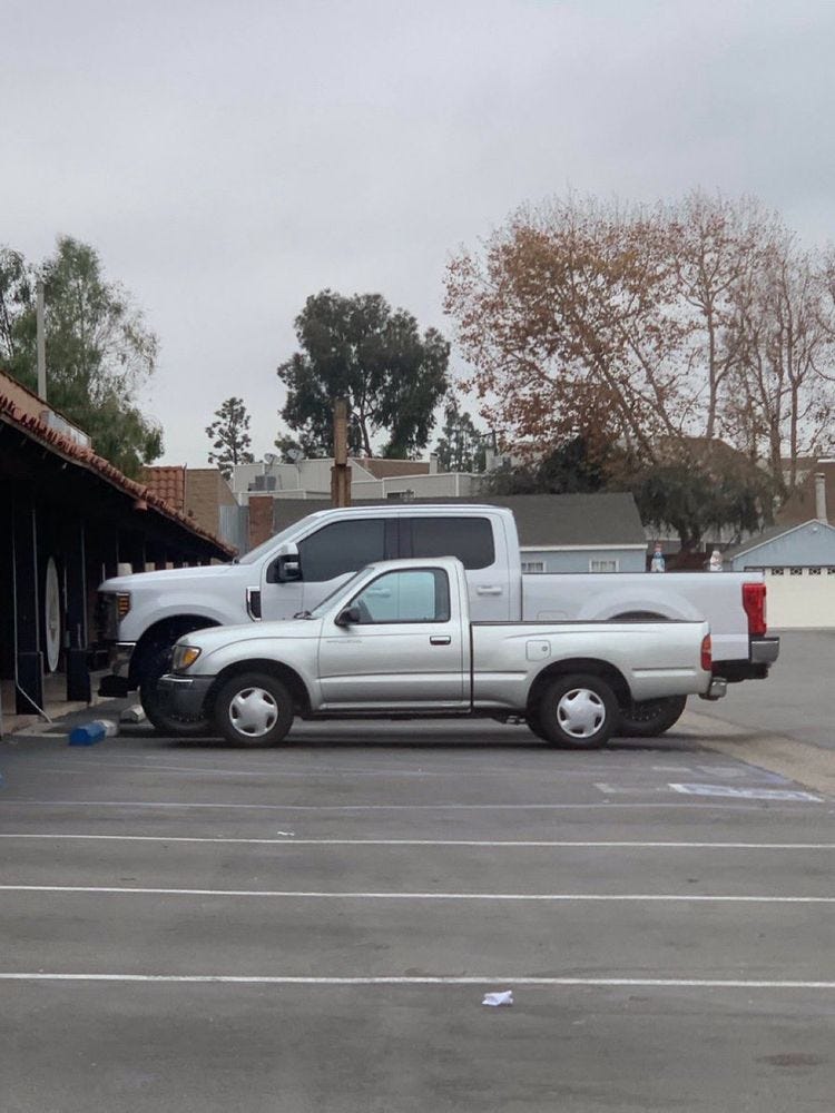 Comparison of older and newer pick-up truck. Although the truck bed is essentially the same, the overall truck size is substantially larger and higher.