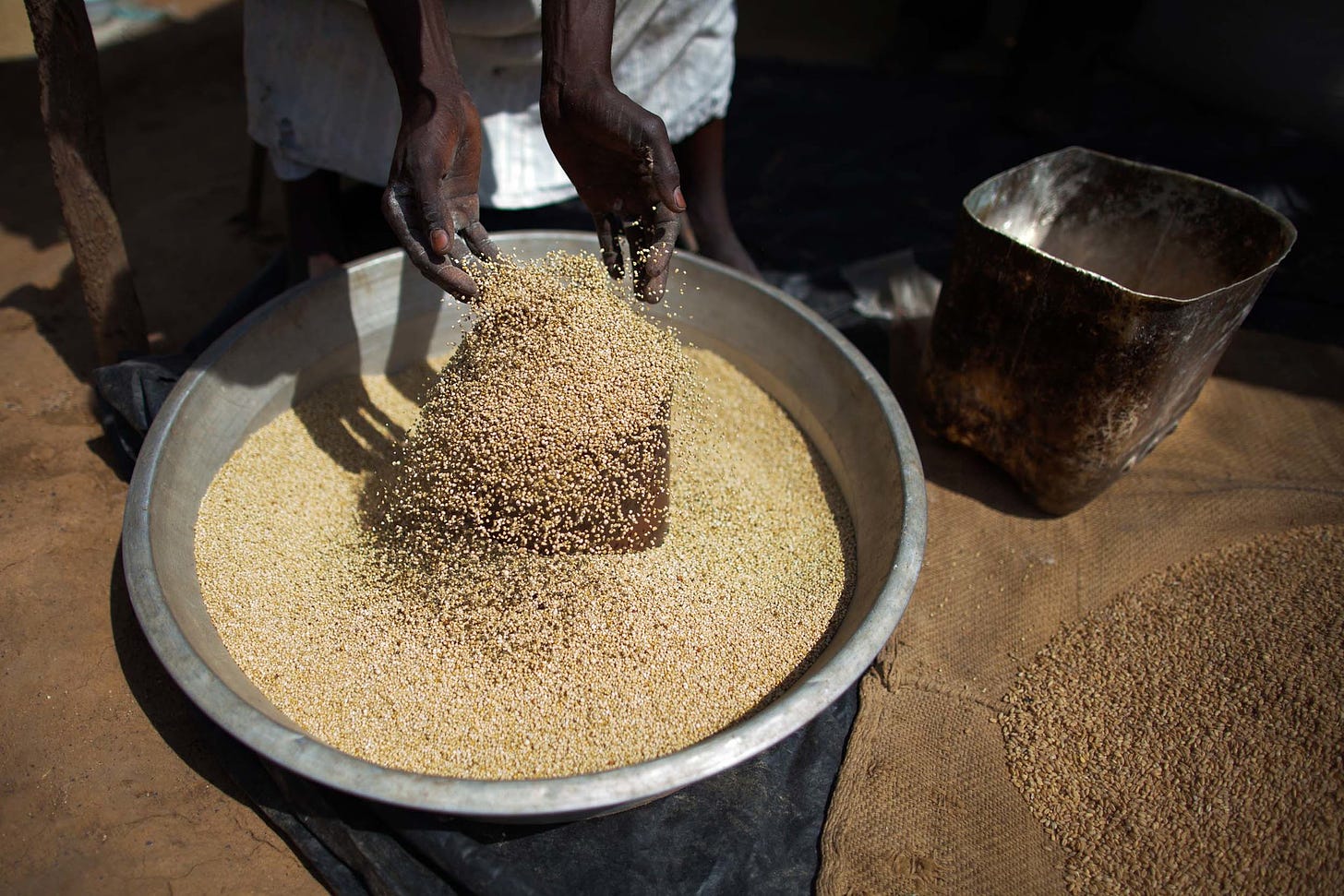 28 August 2013. El Fasher: A miller selects the grain to obtain flour with his automatic mill in Al Moashi market in El Fasher, North Darfur.  Photo by Albert González Farran, UNAMID