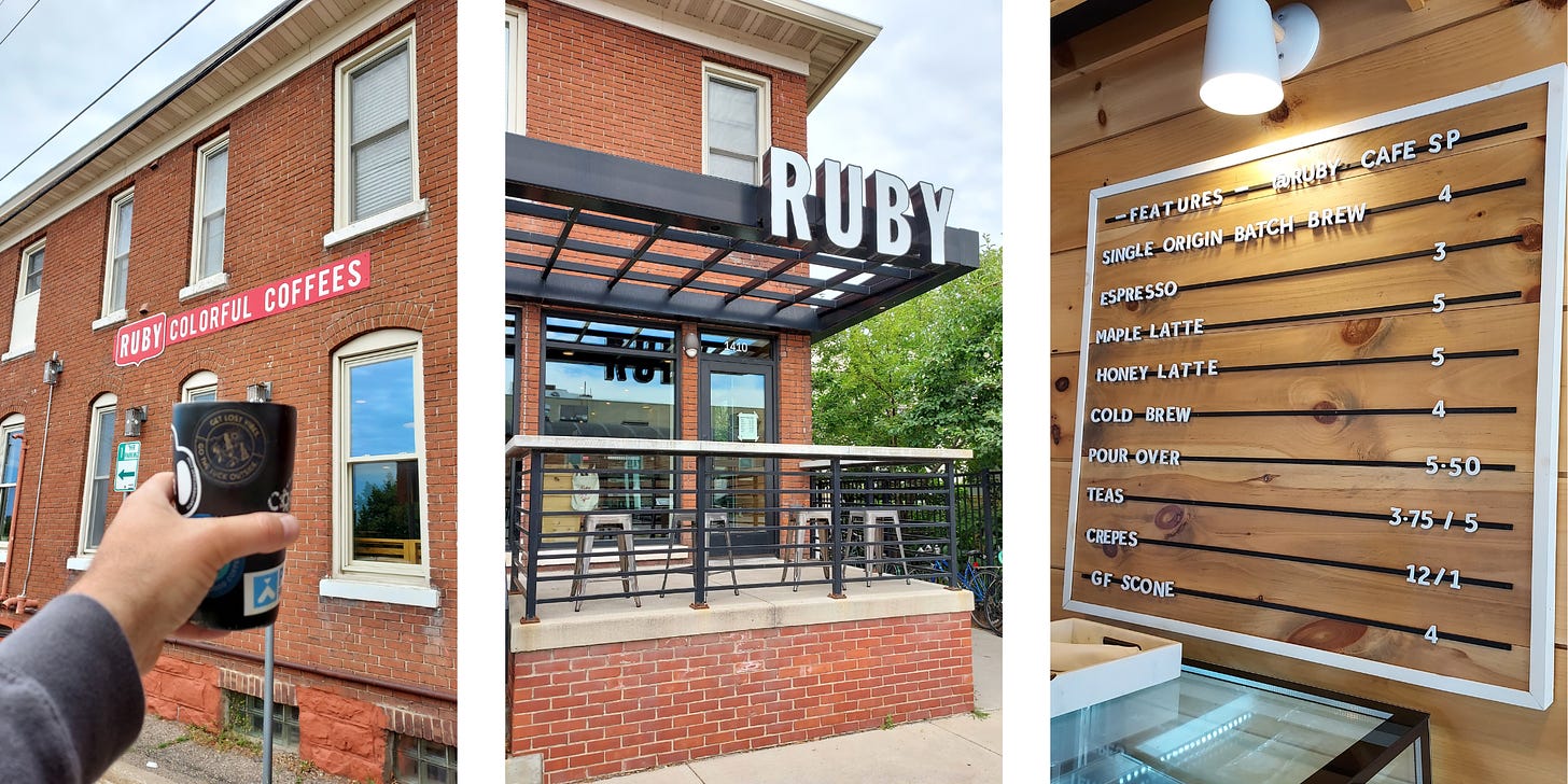 3 images (from left): A hand holds a black tumbler glass up in front of a red brick two-story building. White trimmed windows reflect blue sky, and a sign for Ruby Colorful Coffees is affixed between floors. The front entrance of Ruby coffee with independent letters spelling out R-U-B-Y affixed to a black overhang over a raised, concrete patio with a square, steel grey stools lined up under a railing in front of floor to ceiling windows next to the entry door. White letters are mounted on a knotty wooden wall (horizontal blonde boards) inside of a white frame list the menu items and prices.