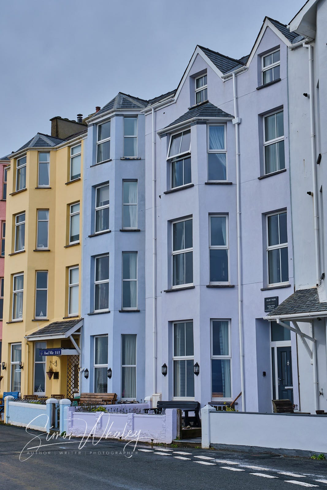 A terrace of four storey properties lining the seafront at Criccieth, in North Wales