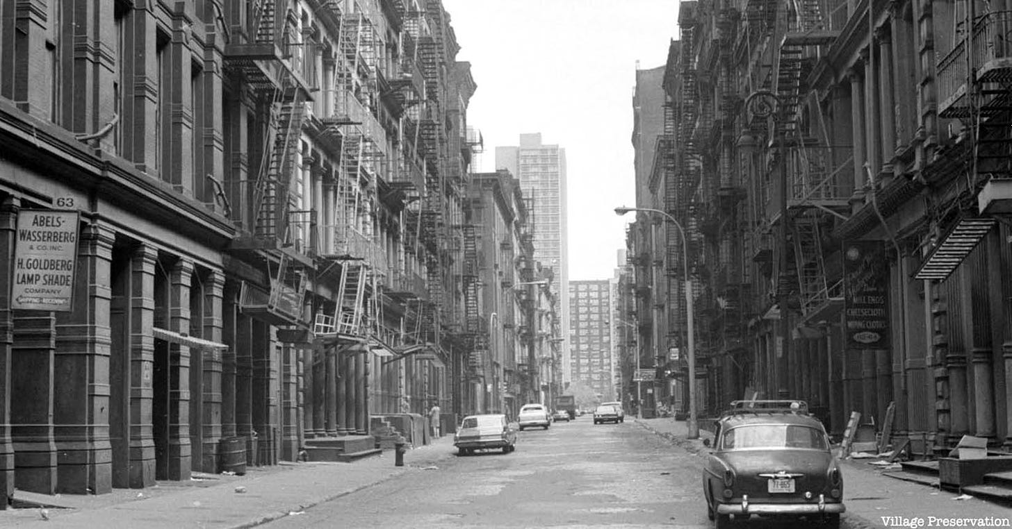 May be a black-and-white image of fire escape, skyscraper and street