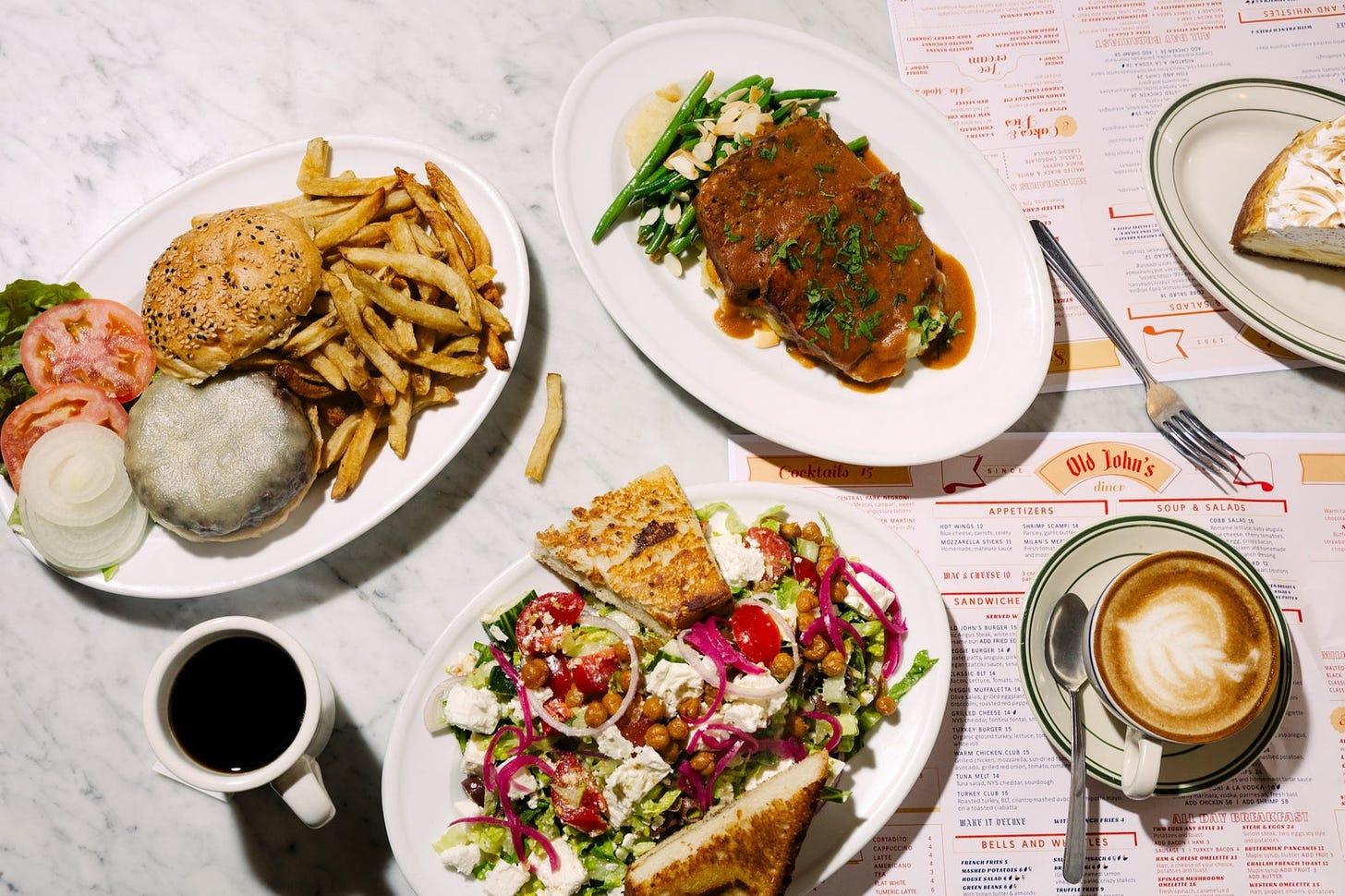 A table of dishes at Old John's set atop the diner's menus.