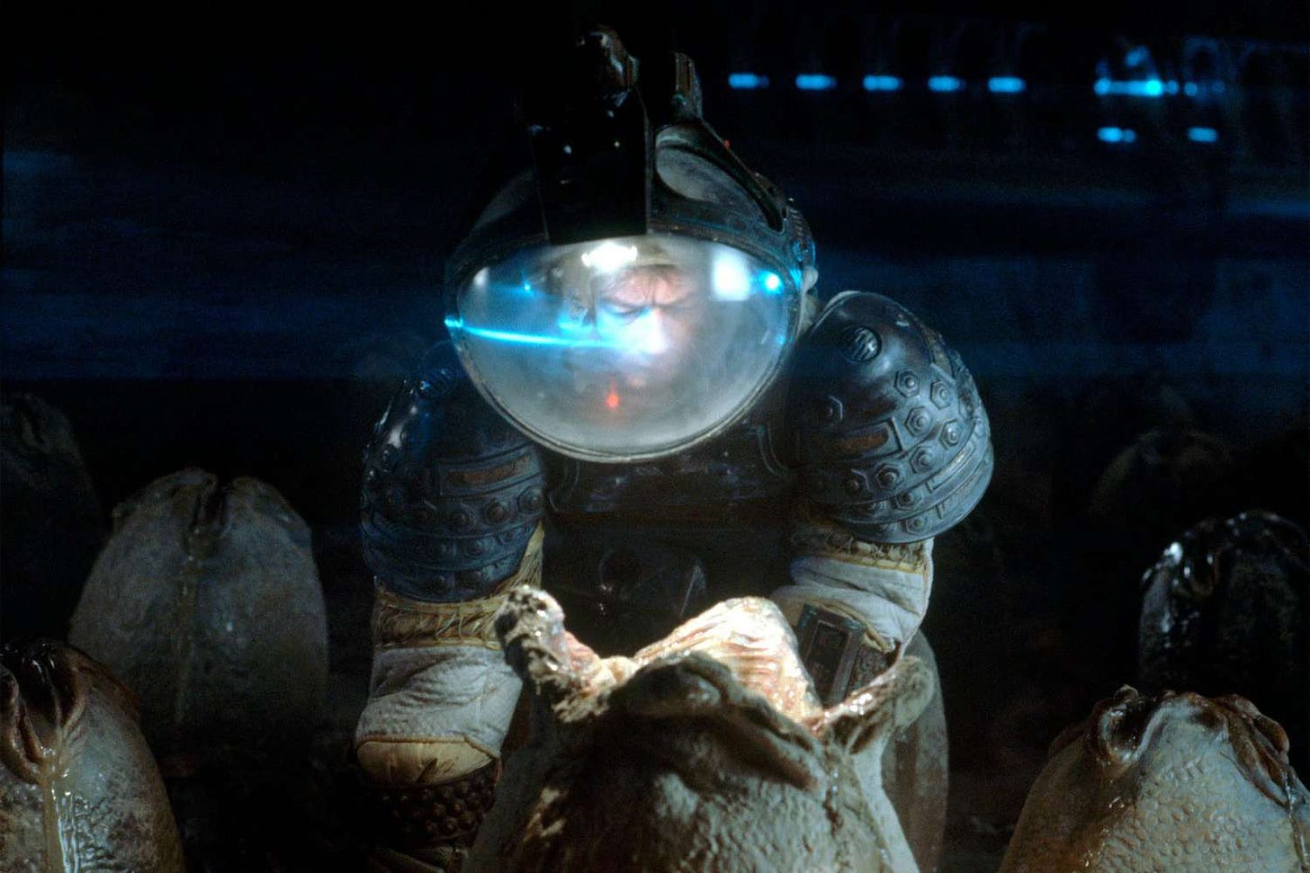 A man in a space suit, leaning over a mysterious and sinister alien egg.