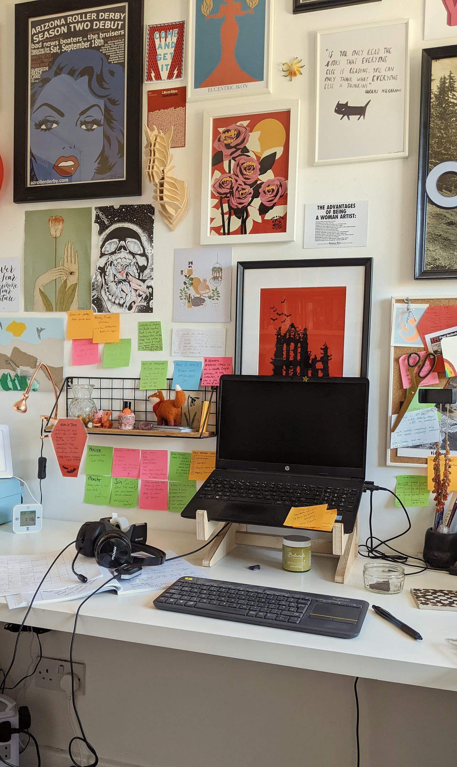 eclectic desk writer laptop setup