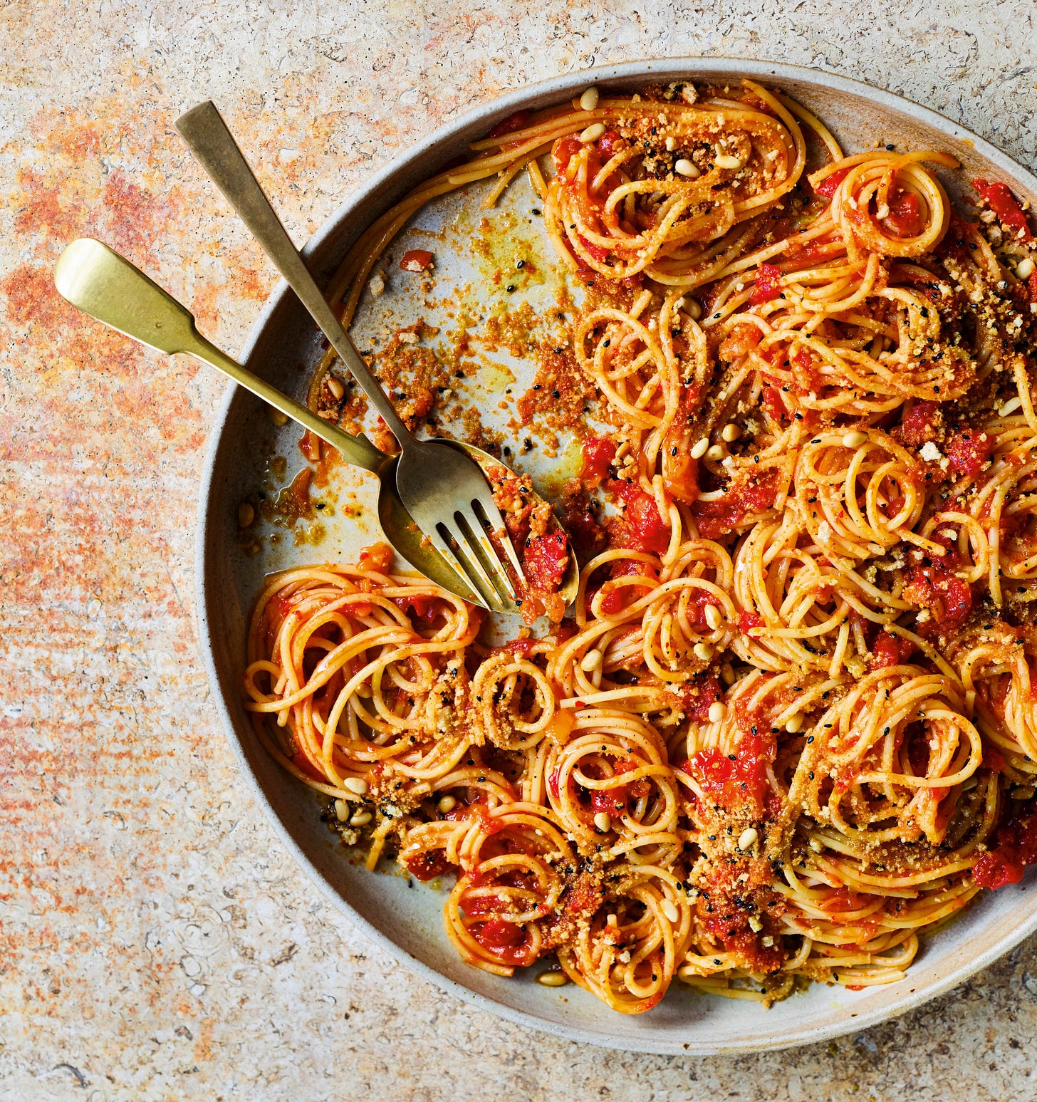 Photo of platter of kimchi and tomato spaghetti with breadcrumbs.