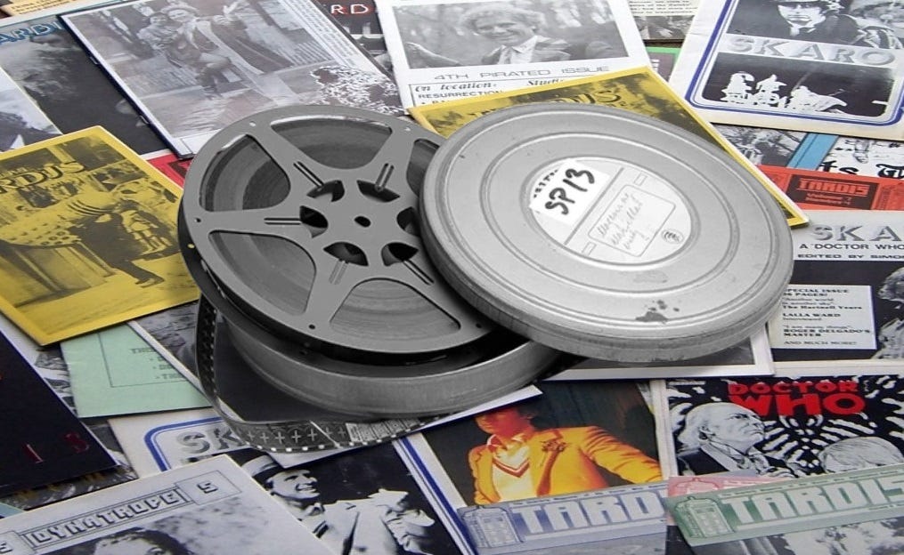 A small 8mm film reel and can on a bed of fanzines (poor quality photo montage)