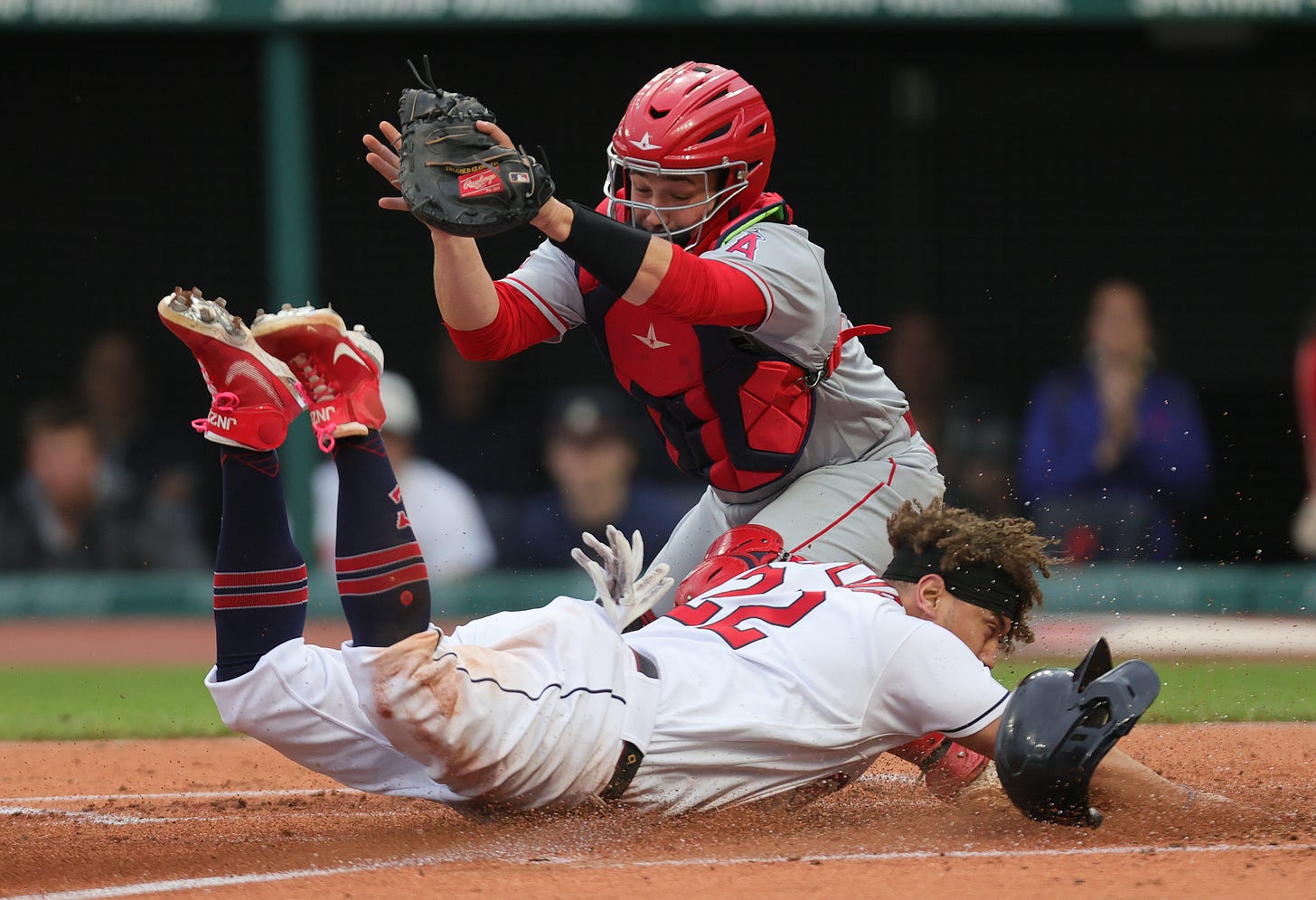 Cleveland Guardians first baseman Josh Naylor slides safely to home plate for a score as Los Angeles Angels catcher Matt Thaiss fields the throw in the second inning, May 12, 2023, at Progressive Field.