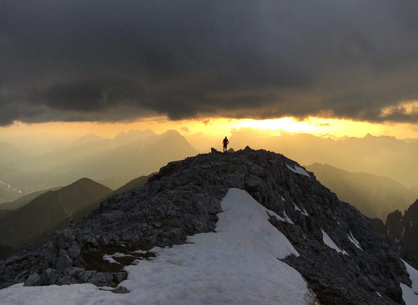 The author standing on top of a mountain at sundown