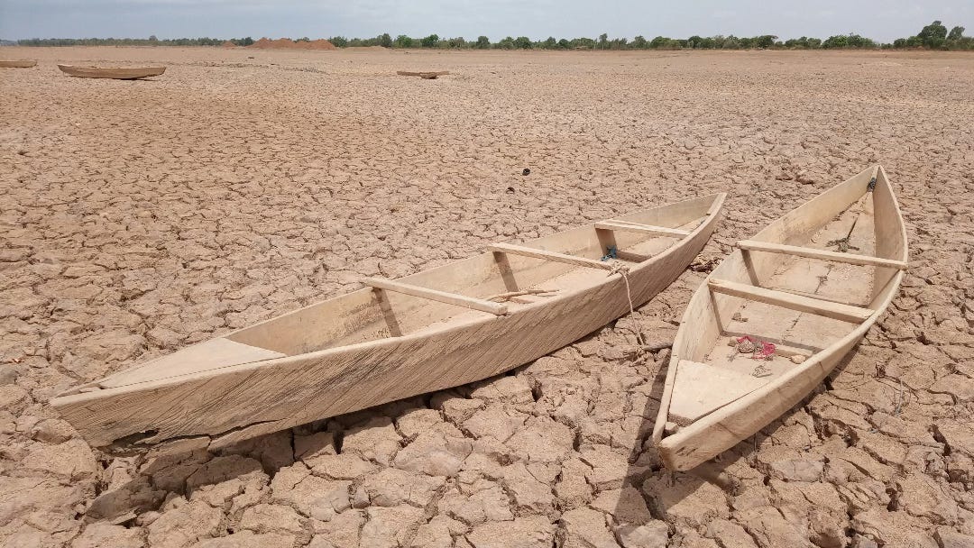 two abanonned small boats in a dried-out lake