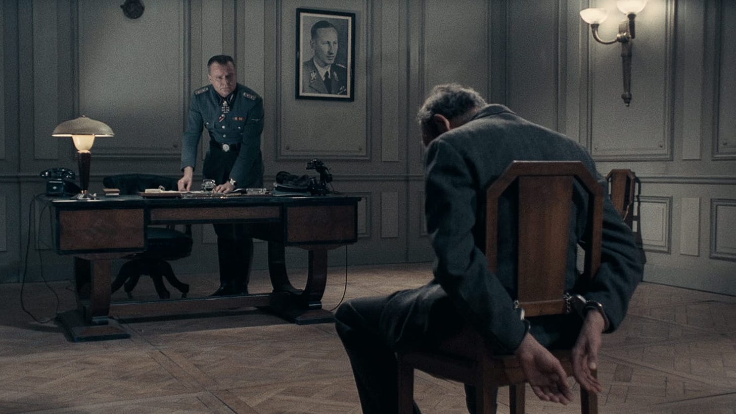 Army of Shadows | Still features a man tied by his hands to a chair, with his head hanging down as if he had been beaten.