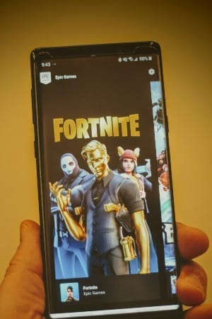 Photo of someone holding a smartphone displaying Fortnight game by Joshua Hoehne / Unsplash