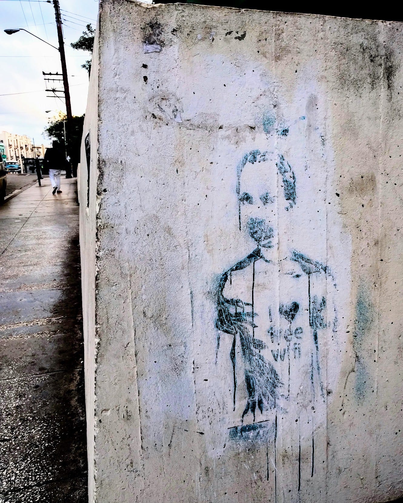 Street art in Havana Cuba depicting a boy with a shirt that says "I heart free wifi"