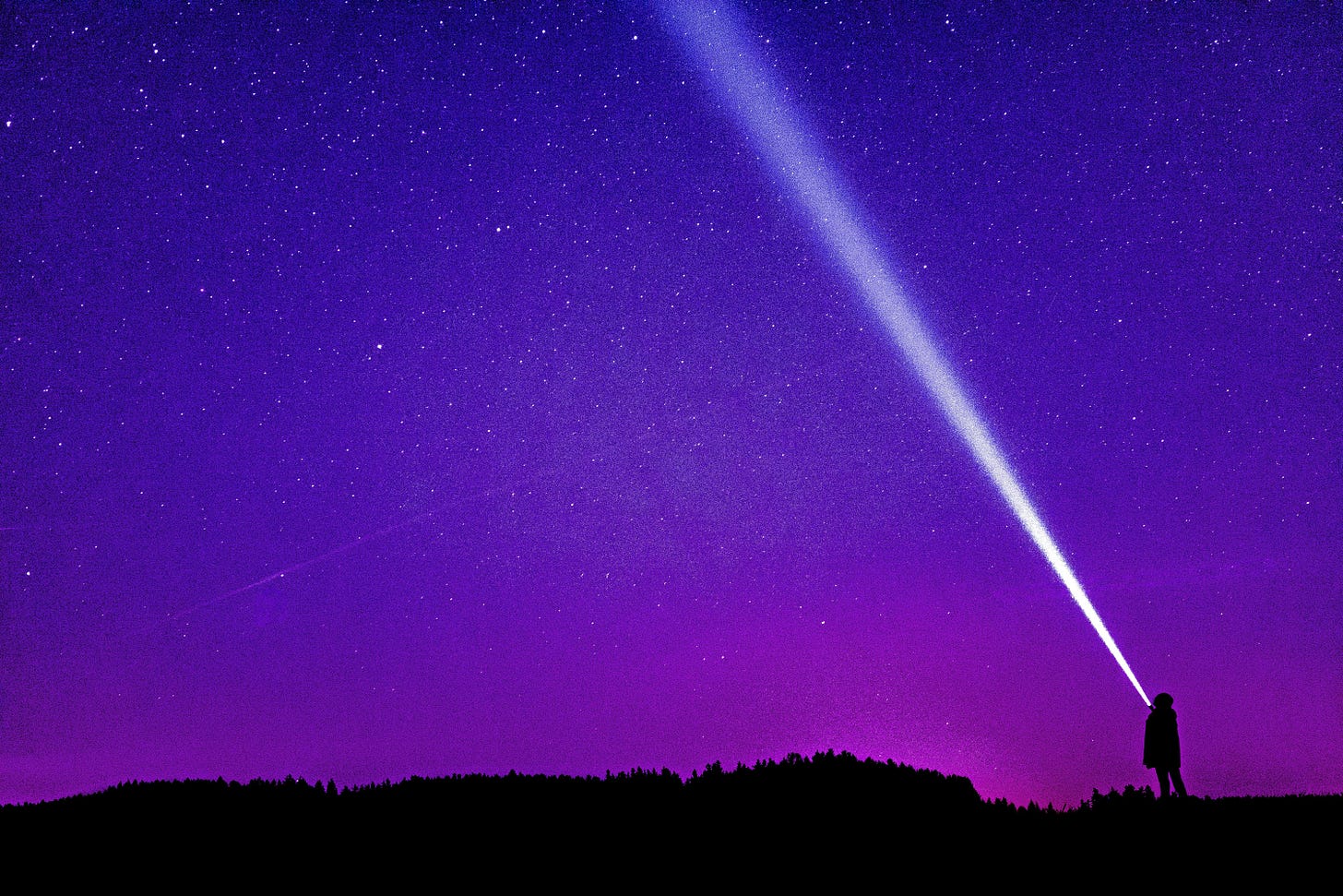 Purple sky and a person with a flashlight