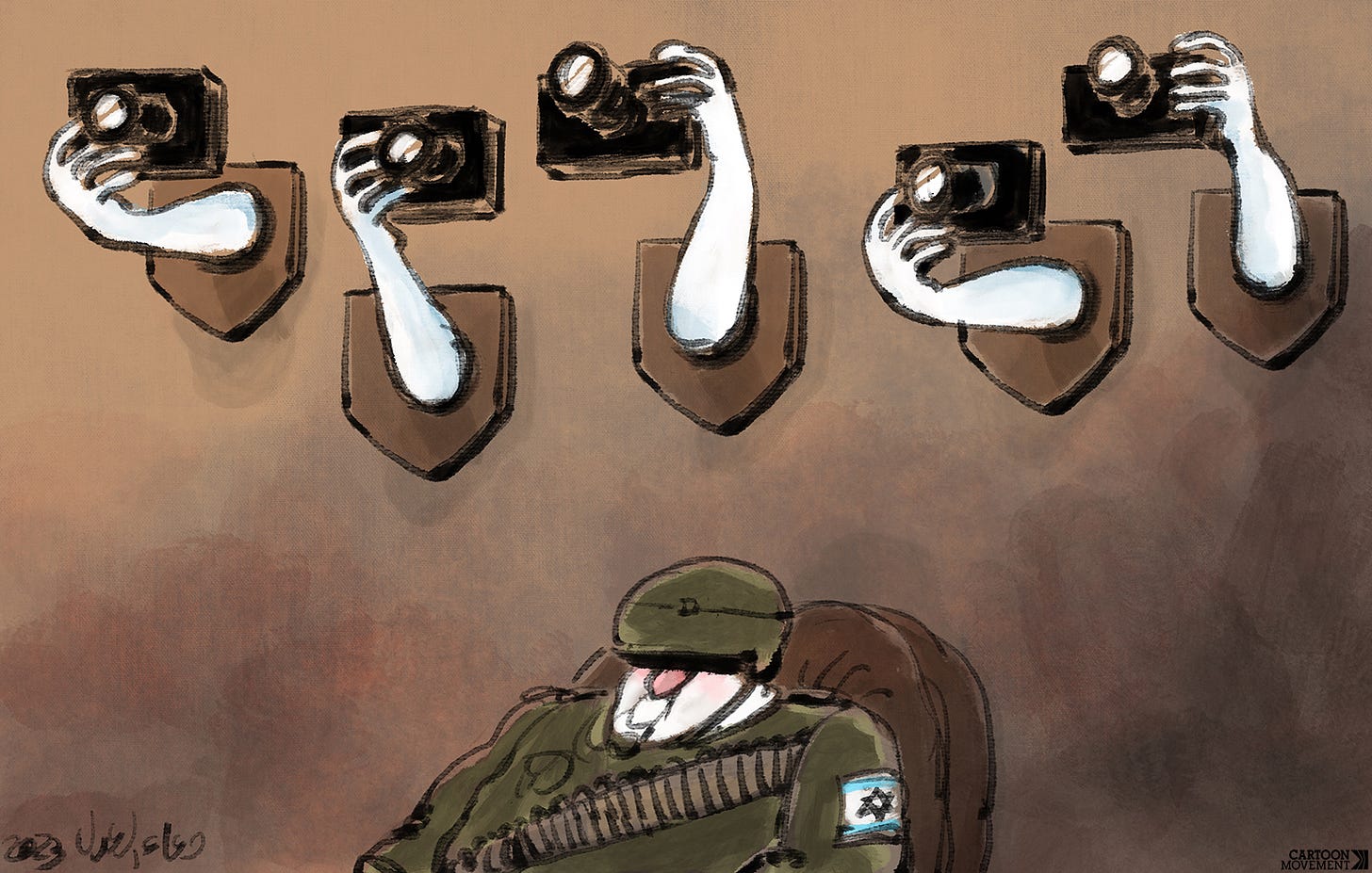 Cartoon showing an Israeli soldier sitting in an armchair, while above him we see trophies on the wall. The trophies are hands holding cameras that have been nailed to wooden shields.