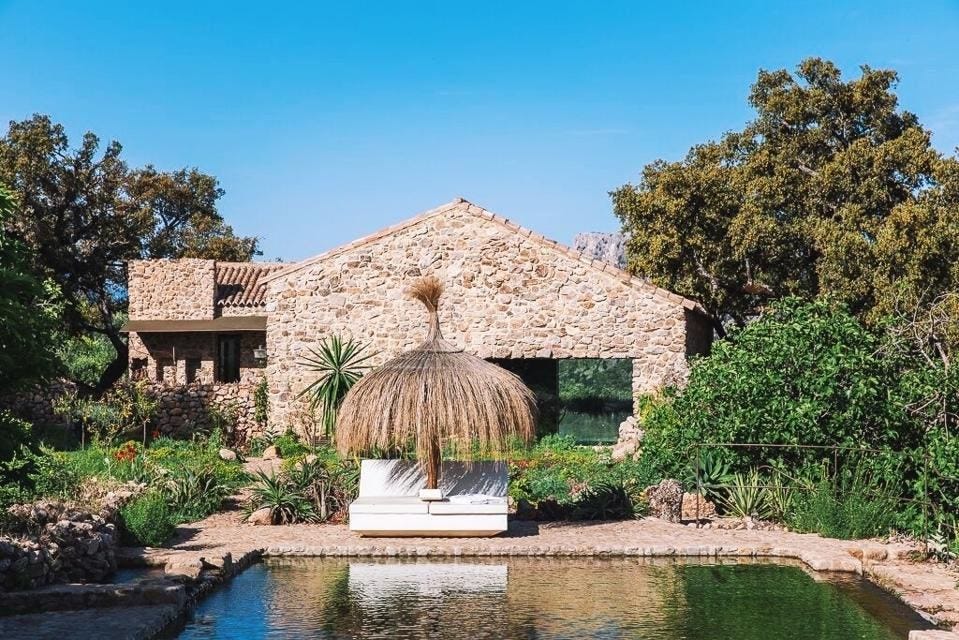 Natural stone and lush gardens surround the spring-fed swimming pool at La Donaira, Spain