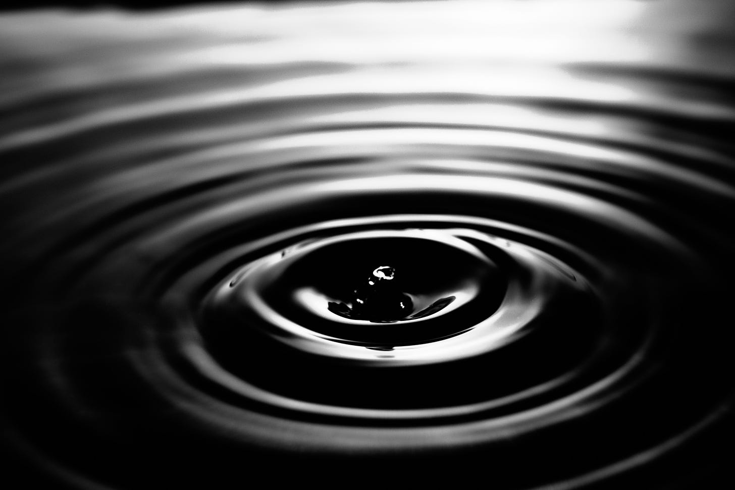 Black and white photo of concentric circles created by water drops