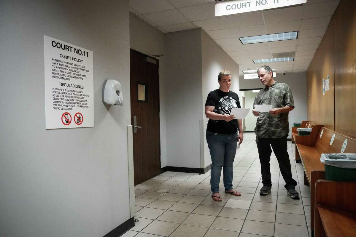 Food Not Bombs volunteers Shere Dore, left and Nick Cooper talk after their cases were postponed Thursday, June 1, 2023, at a municipal court building in Houston.