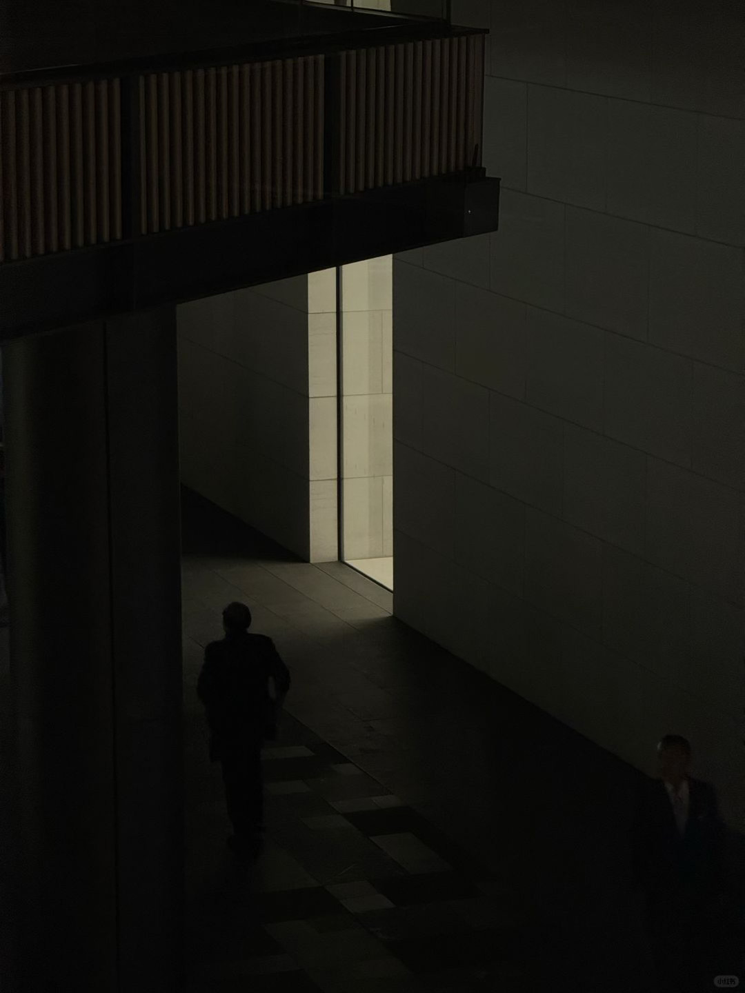 A shadowy figure passes by a side window at Apple Taikoo Li Chengdu.