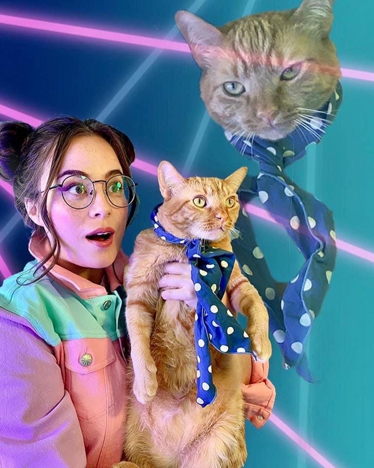 Photo of Sarah Whittle holding her cat with a background of lasers