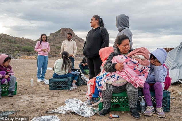 Mexican migrant Veronica Marquez, 36, comforts her son Mariano, 5, while waiting to be apprehended by U.S. Customs and Border protection officers after crossing over into the U.S. on June 25, 2024