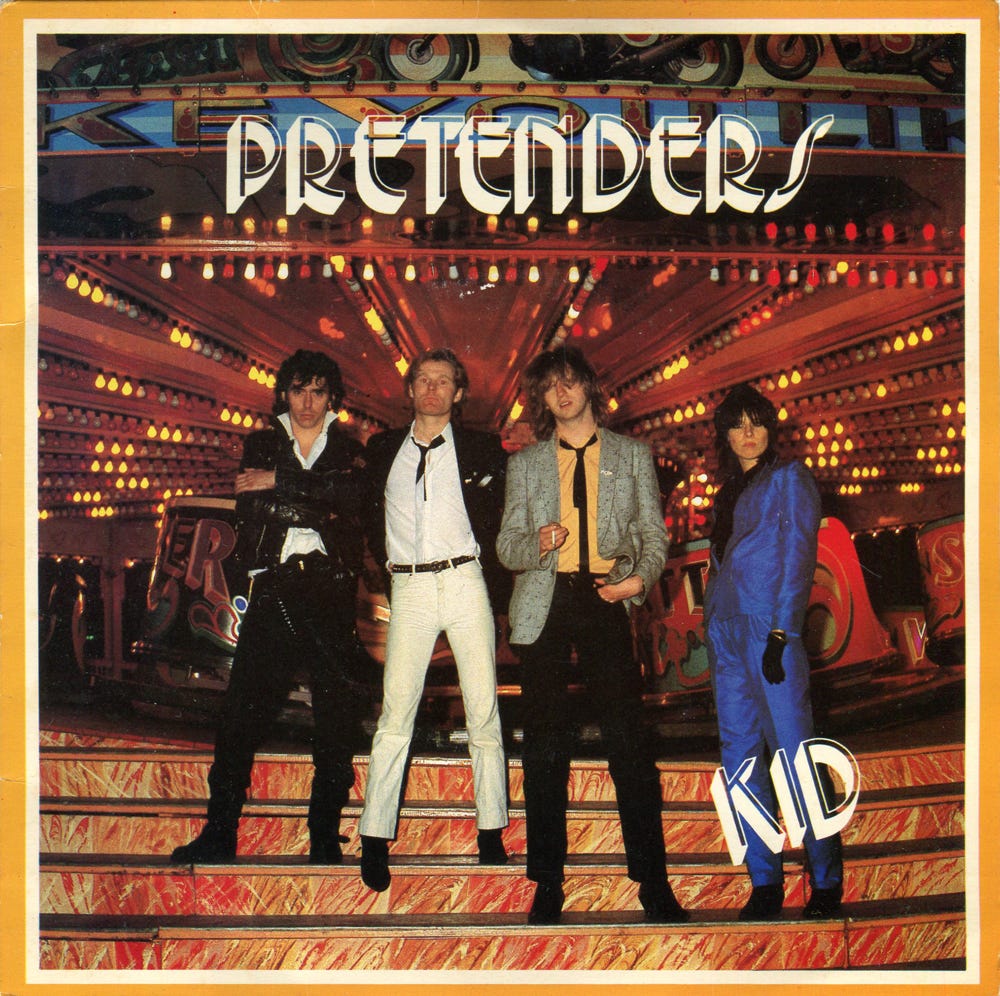 Picture sleeve for the single Kid, with a photo of the band in a fairground.