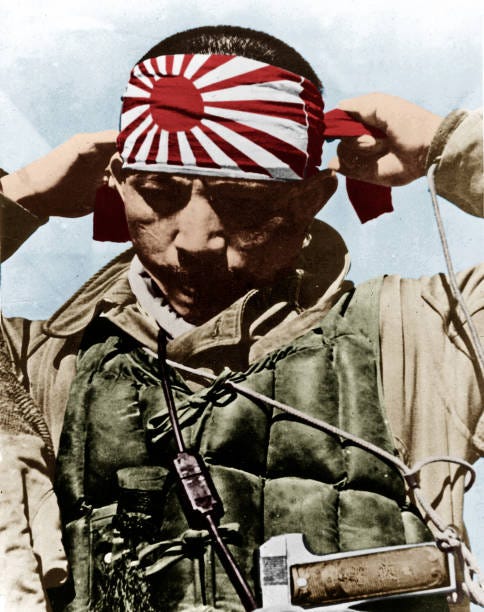 Japanese kamikaze putting on his forehead bandeau with rising sun ...