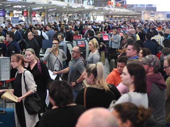 Huge queues are seen at Sydney airport after extra security measures are introduced in the wake of the terror plot. Picture: AAP Image/Dean Lewins.