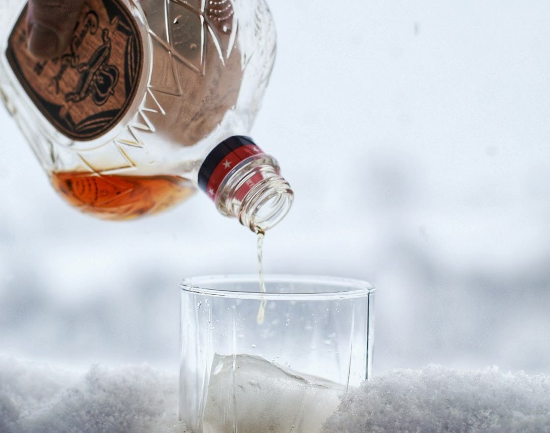 a person pouring a beverage into a glass a person pouring a beverage into a glass