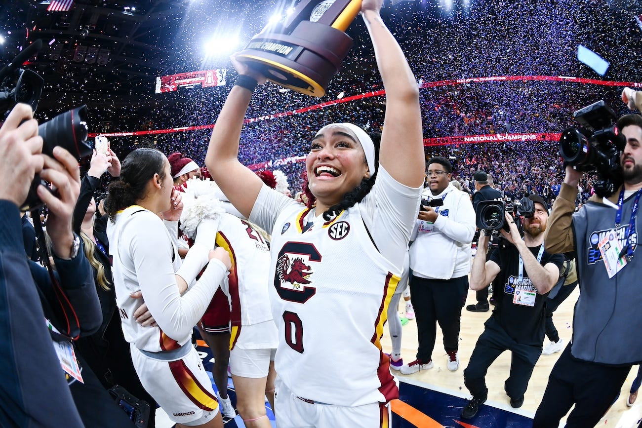 Oceanside native Te-Hina Paopao raises the national championship trophy after South Carolina beat Iowa, 87-75, on Sunday in Cleveland. Paopao, a combo guard, scored 14 points in the title game. Photo credit South Carolina Athletics