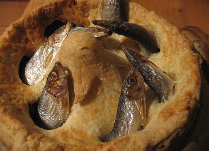 A delectable golden-crusted pie with a half-dozen or so beautiful sardine heads pokin’ outta the crust. Yum yum yum!!!