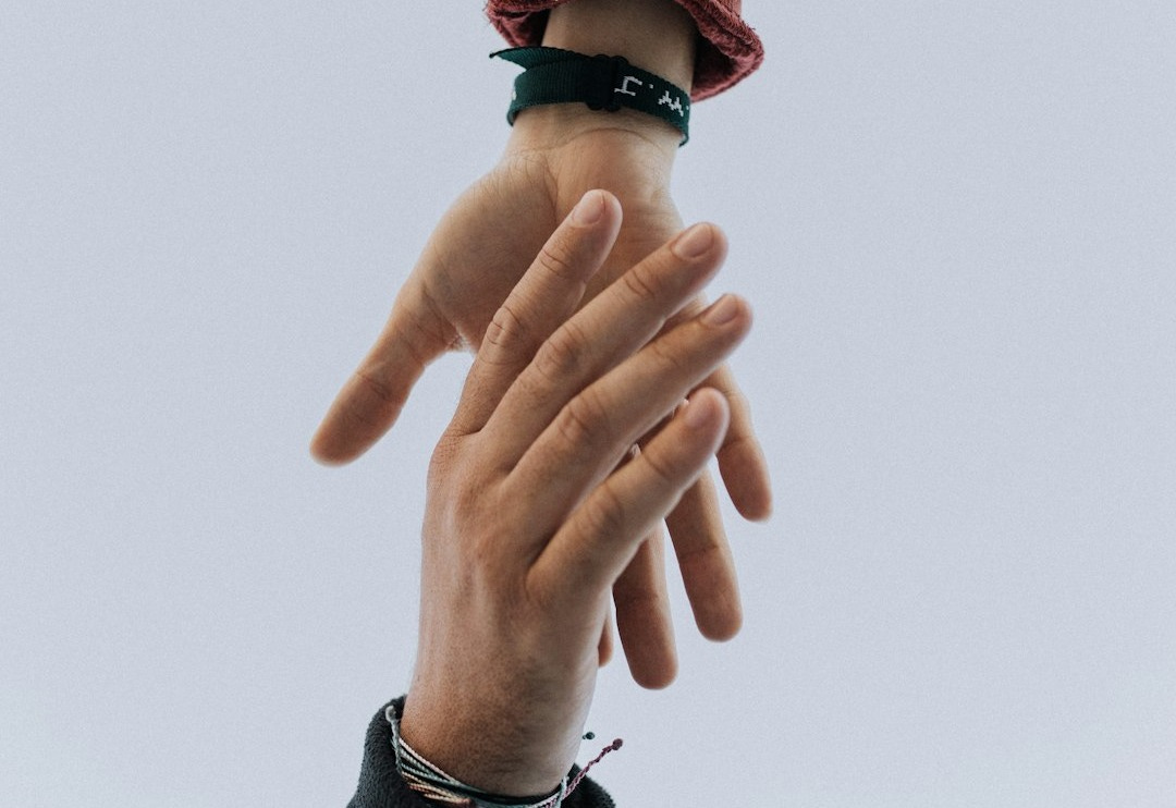 view of two persons hands view of two persons hands