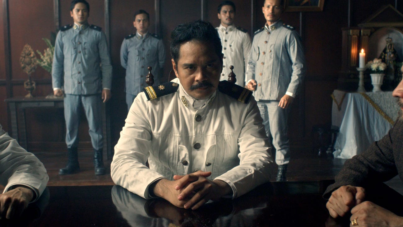 Screencap of Heneral Luna, with the main character looking sternly at the camera surrounded by soldiers