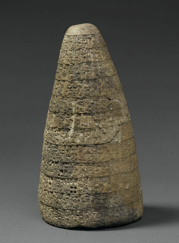 Standing upright, this cone of stone is rounded on all edges, and filled with Sumerian symbols all along its sides.