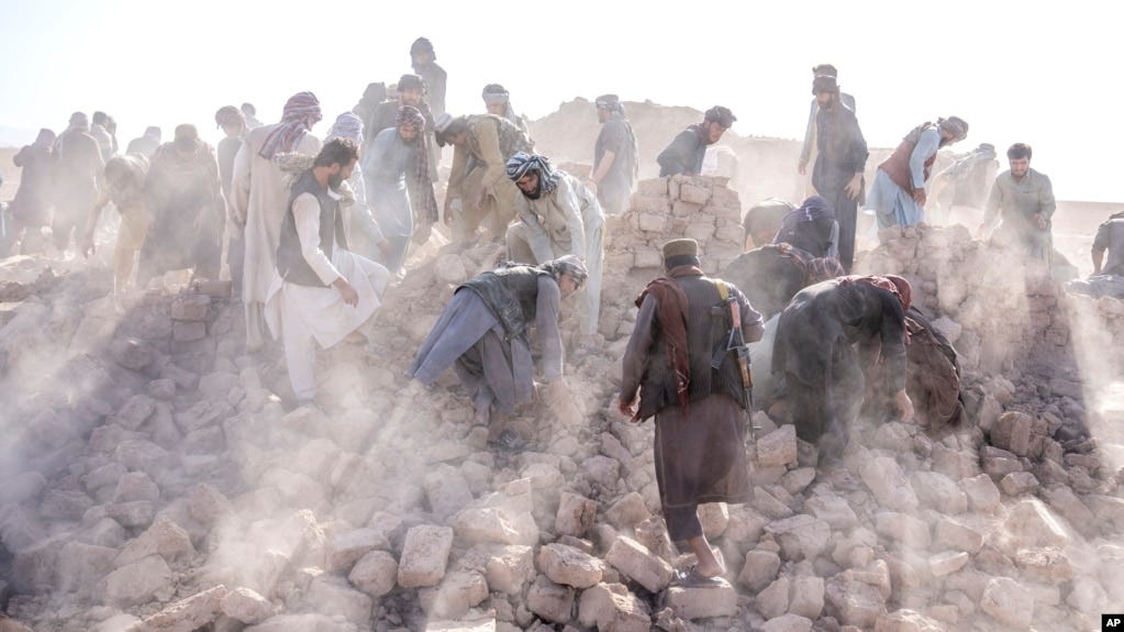 Afghan volunteers clean up rubble after an earthquake in Zenda Jan district in Herat province, western Afghanistan, Oct. 11, 2023.