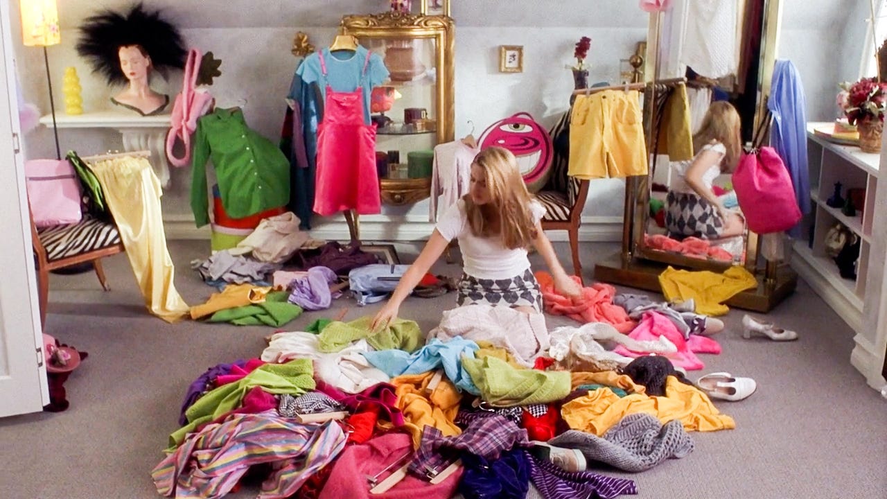 Cher in Clueless picking out an outfit in her closet.