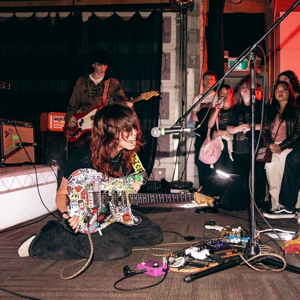 cherry pick on the floor of green auto music, screaming at her gear