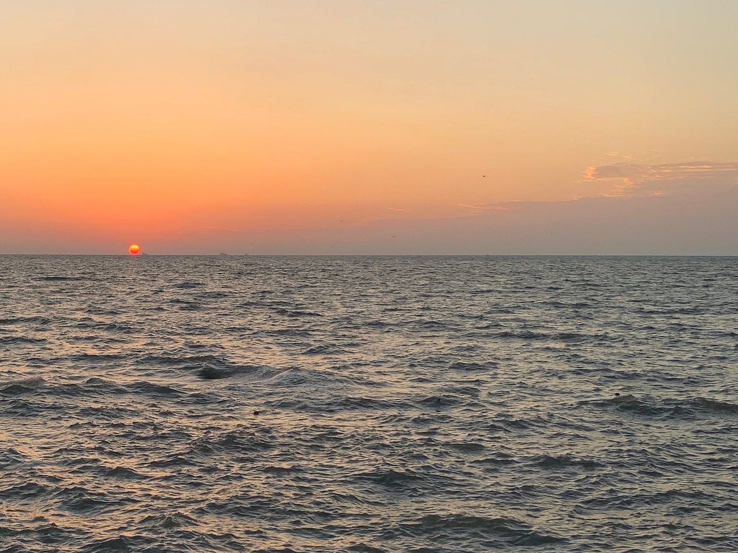 A sunset and its glow on the Indian ocean. The moment captured is of the Sun’s lower edge touching the horizon.