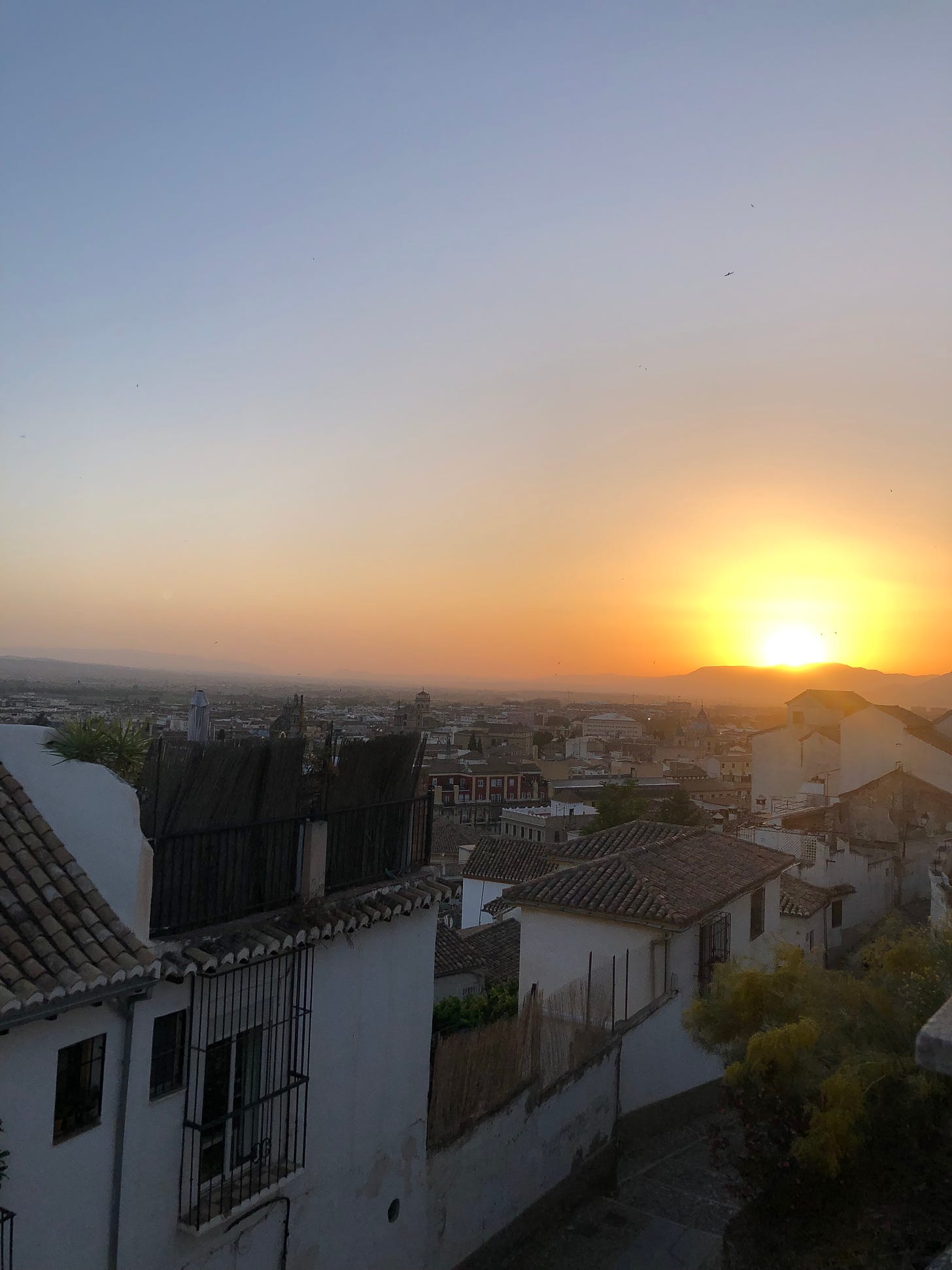 A picture of a sunset over the city of Granada, Spain